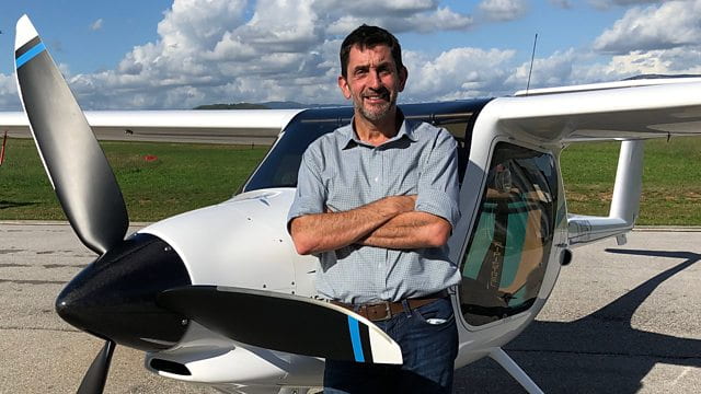Justin Rowlatt BBC journalist in front of a plane